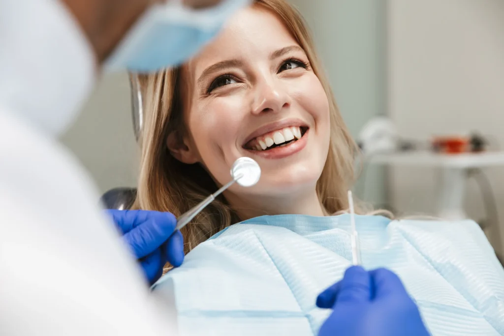 A smiling woman in a dental chair during a routine checkup
