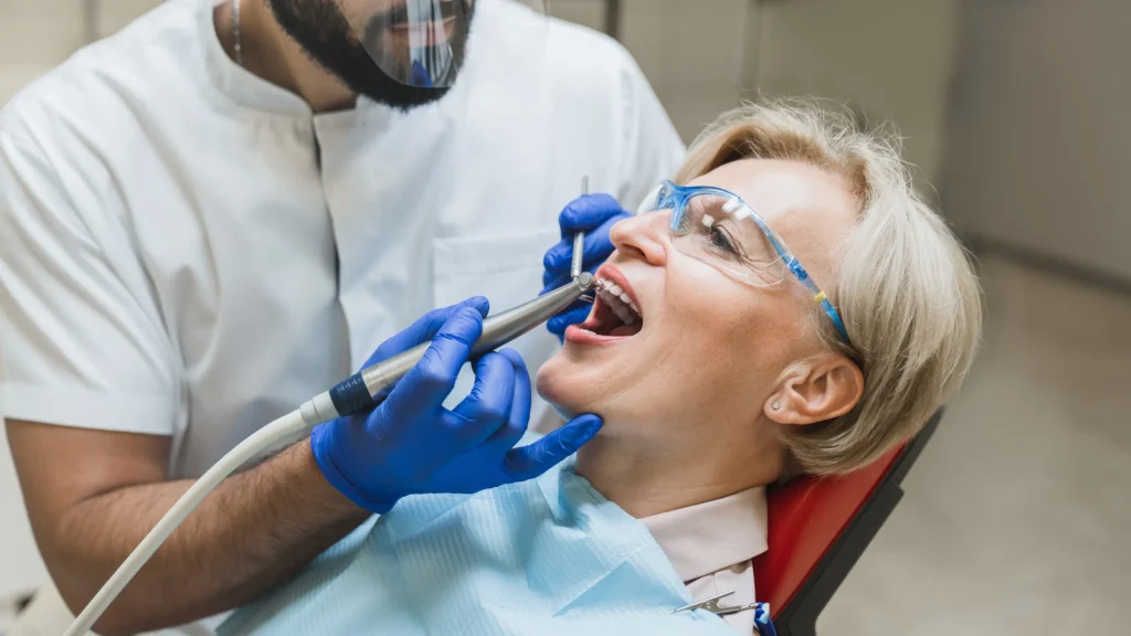 Dentist treating a patient reclined in a dental chair