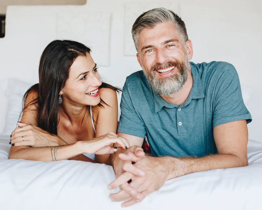 Smiling couple lying on a bed