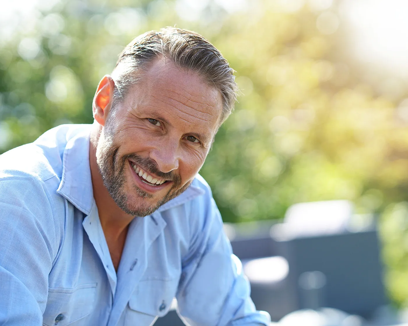 Smiling middle-aged man outdoors