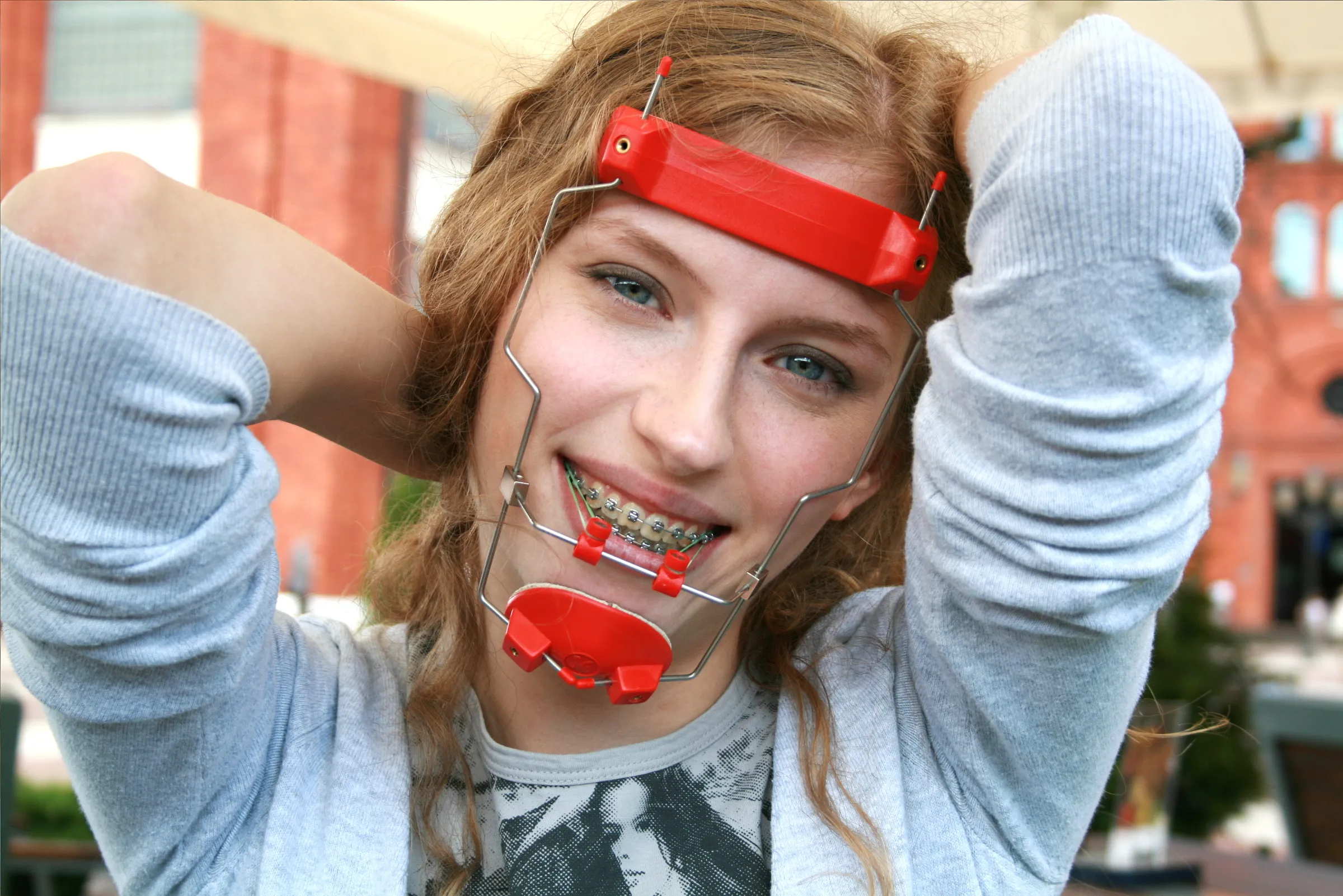 Teenager wearing orthodontic headgear