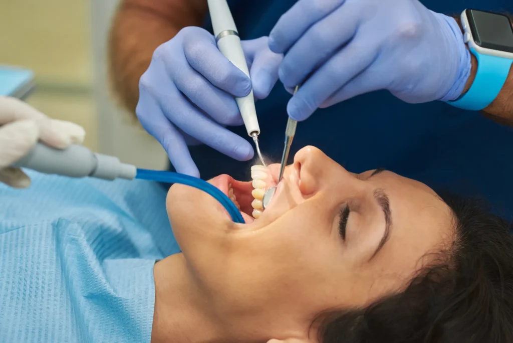 Patient having a deep cleaning with suction