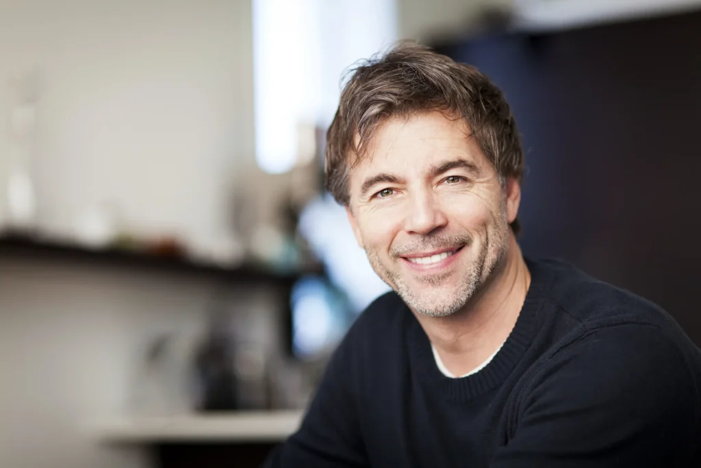Smiling middle-aged man indoors