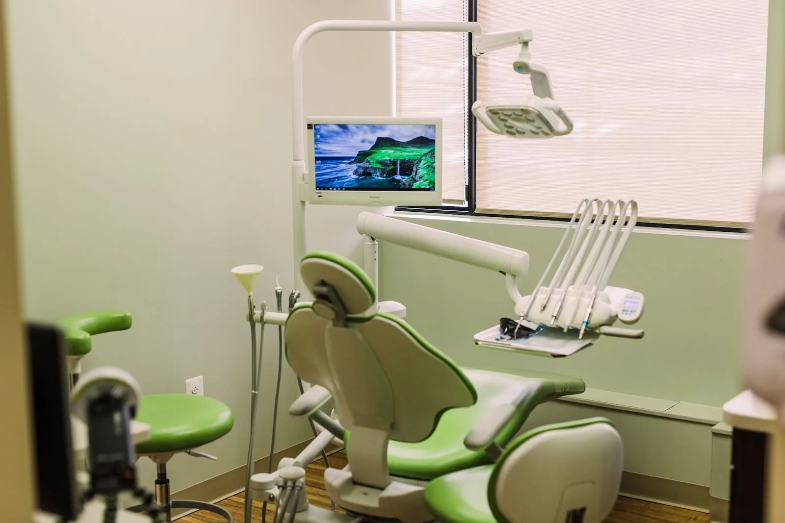 A dental treatment room with a chair and equipment
