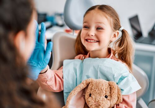 Child at dentist working with dental hygienists