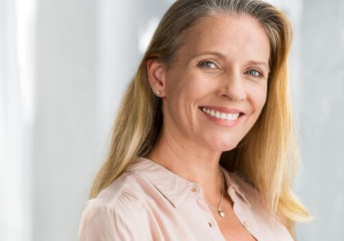 Adult woman smiling with dental work completed