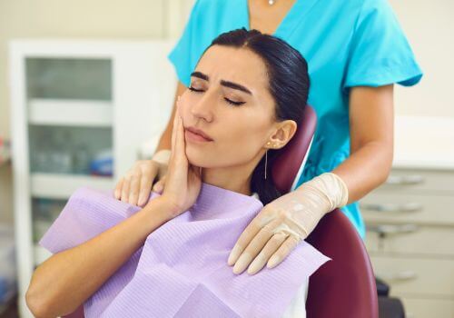 Woman in a dental chair receiving treatment for tooth infection