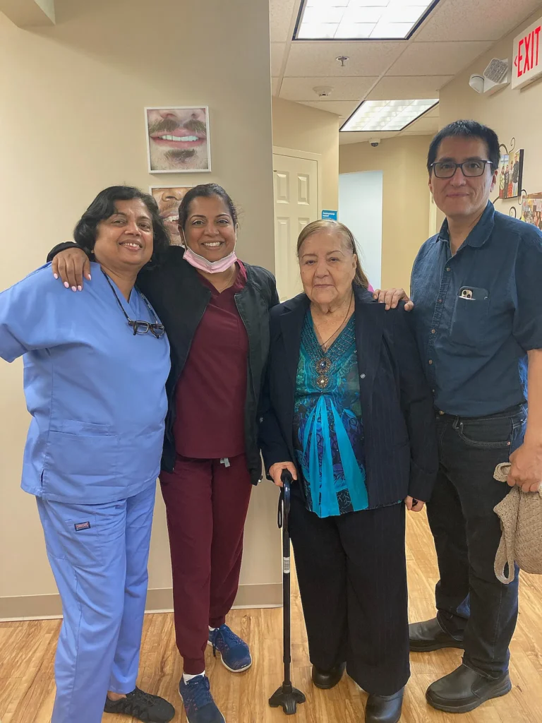 Four team members standing with a patient in the practice corridor