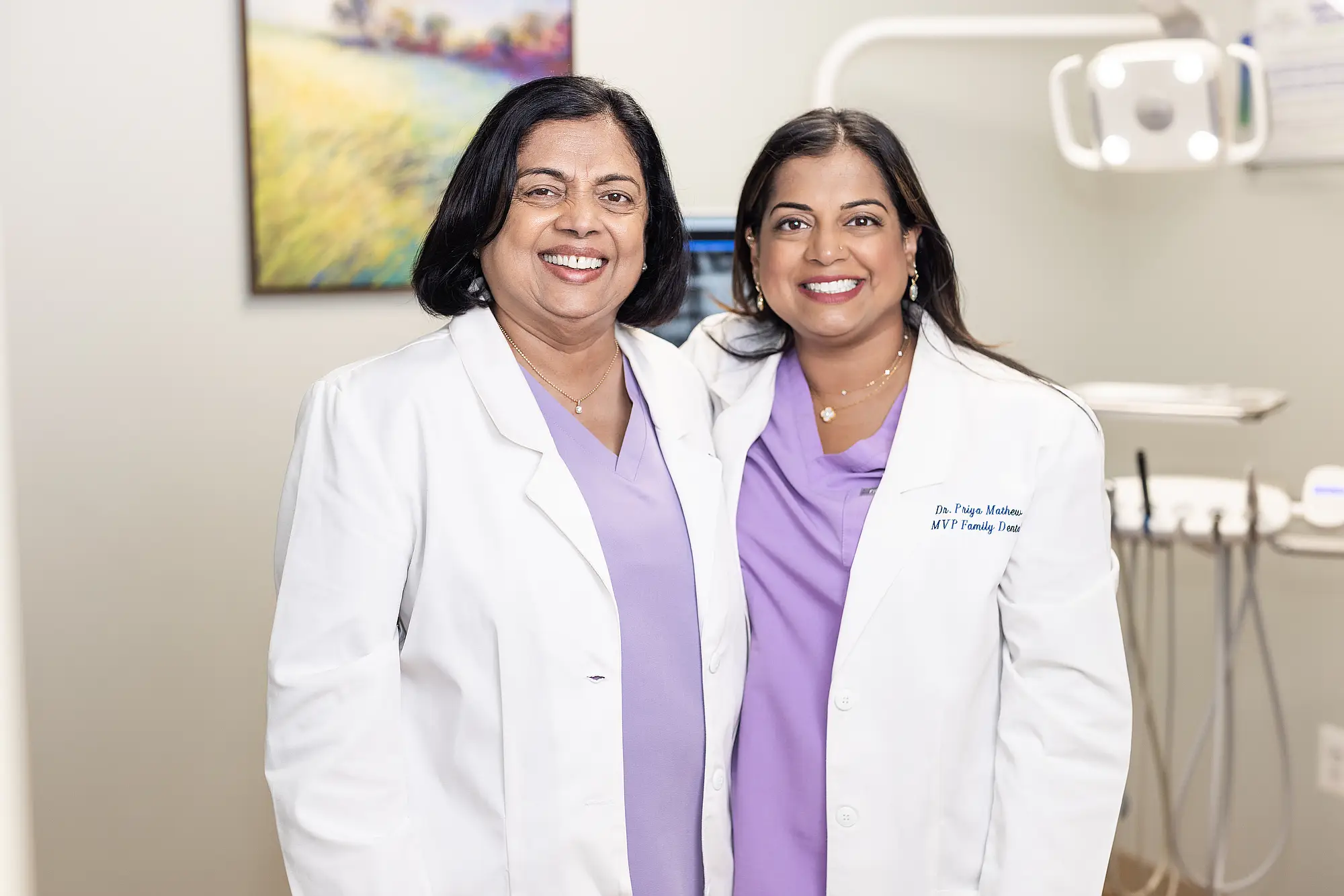 Dr. Vineetha Thomas and Dr. Priya Mathew standing together in a treatment room