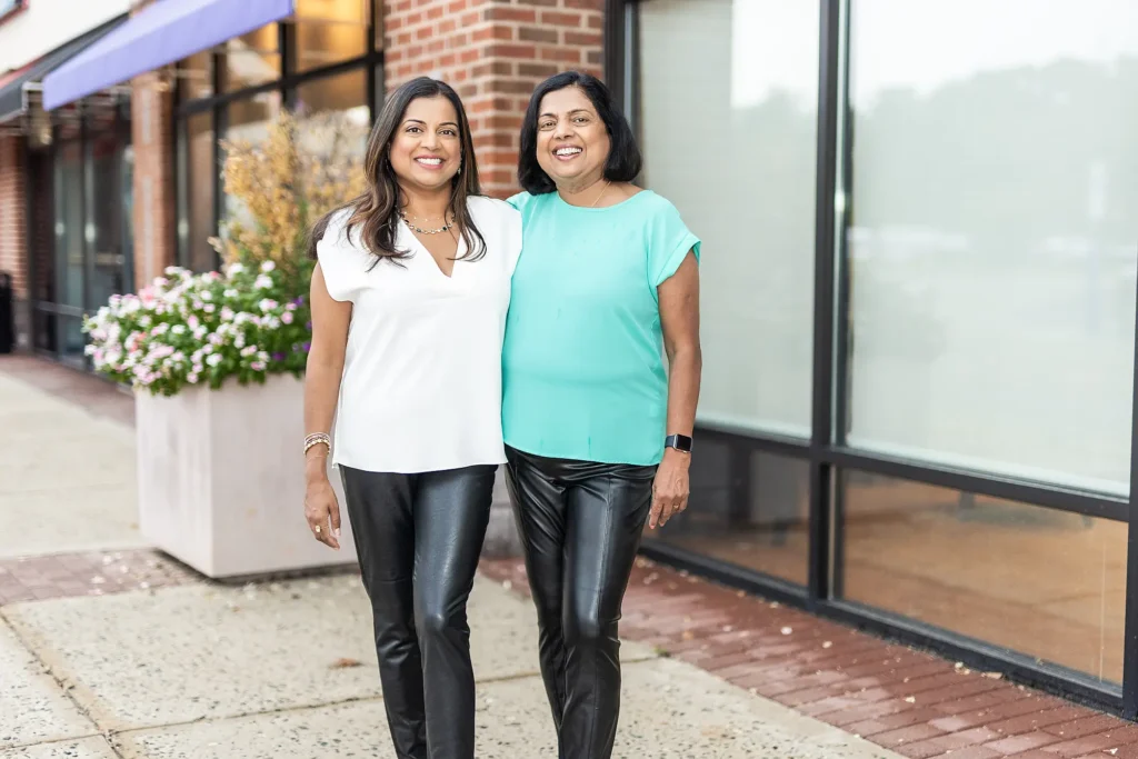 Dr. Priya Mathew and Dr. Vineetha Thomas walking outside the practice