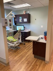 Treatment room with overhead light and chairside computer