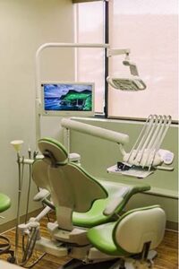 Dental chair and overhead light in a treatment room