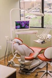 Treatment room with a chairside screen showing patient imaging