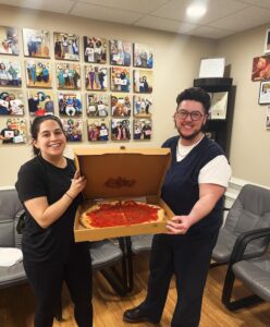 Two team members with a tray of food in the staff room