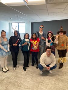 The team in costume in the office