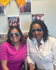 Two team members wearing sunglasses in the office