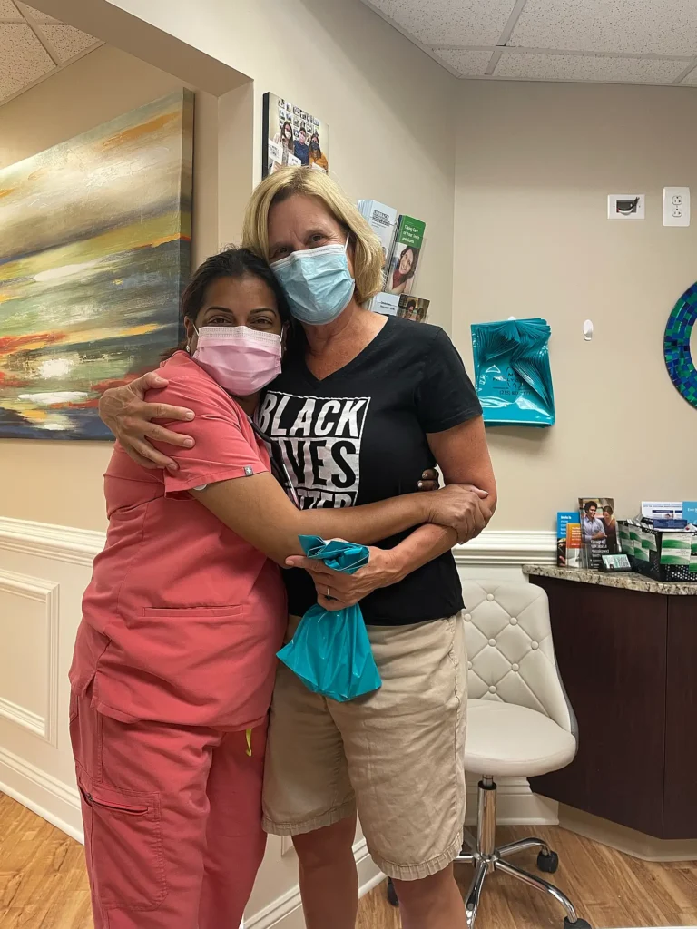 Dental team member sharing a warm hug with a patient at MVP Family Dental