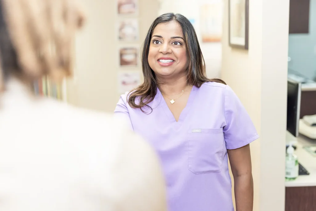 Dr. Priya Mathew in scrubs at the practice