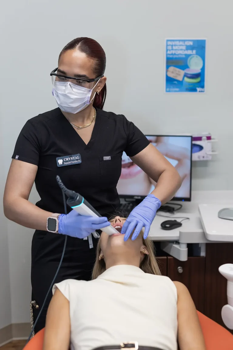 Hygienist using an intraoral scanner on a patient