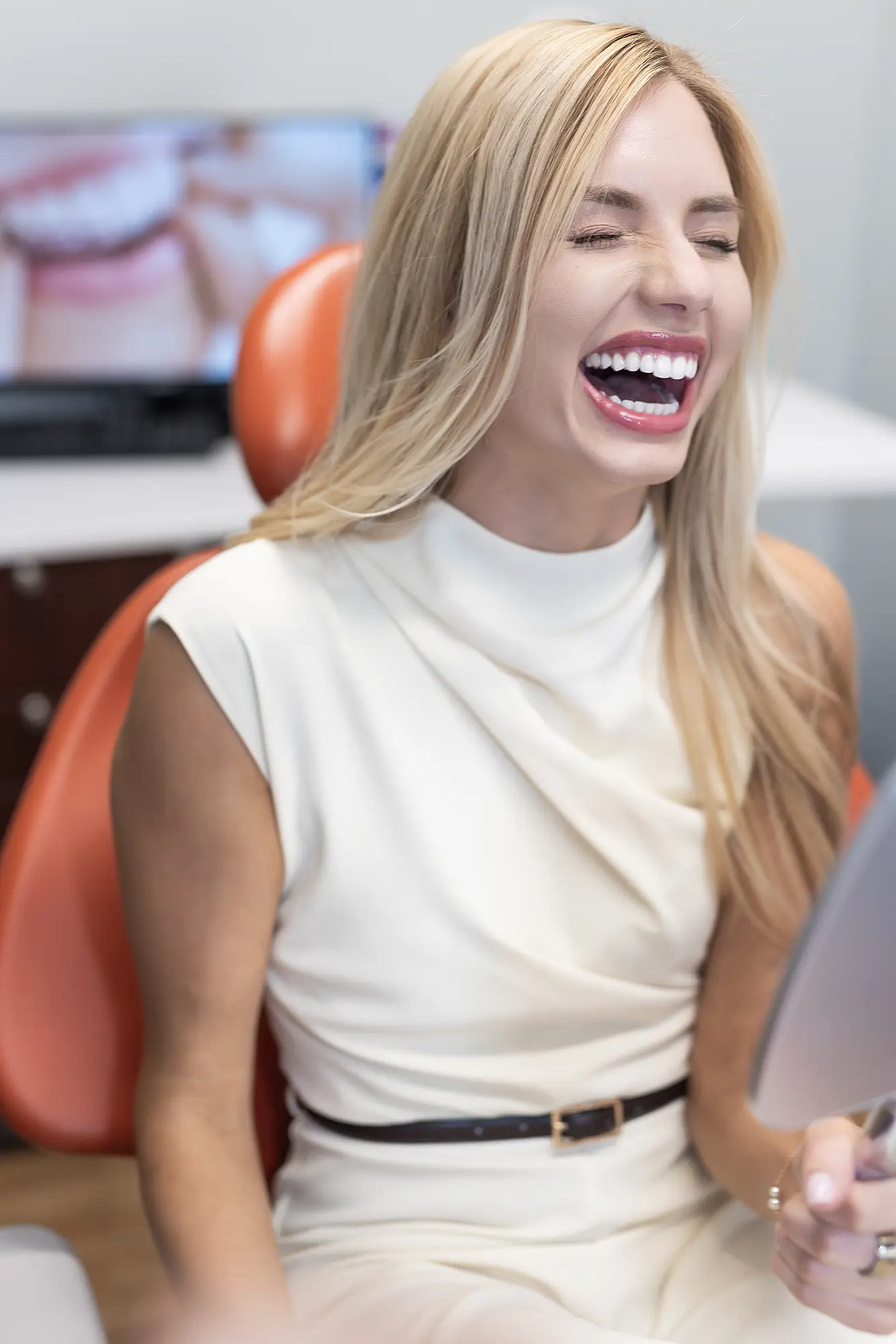Patient laughing in a dental chair