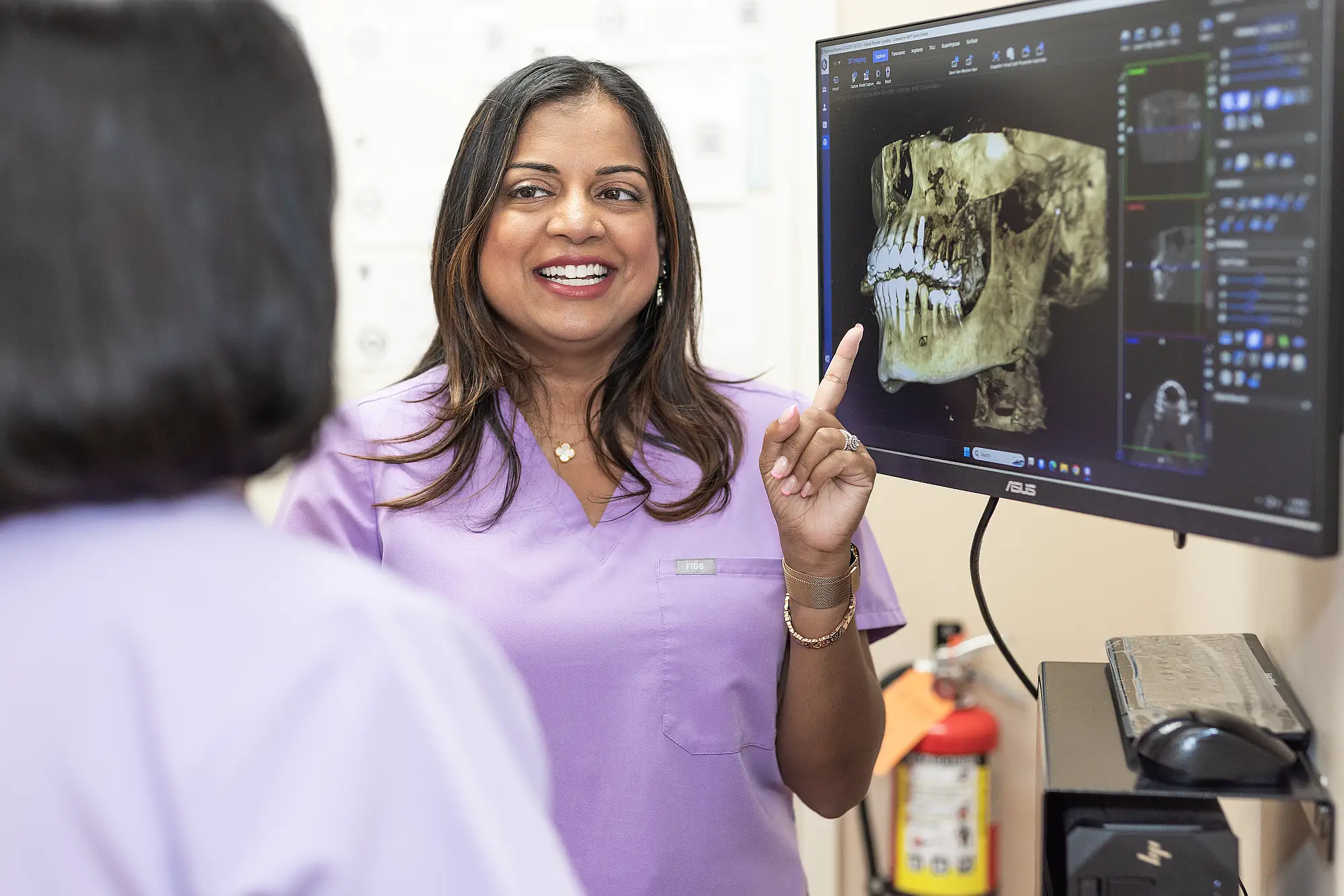 Dr. Priya Mathew discussing a 3D scan with a colleague