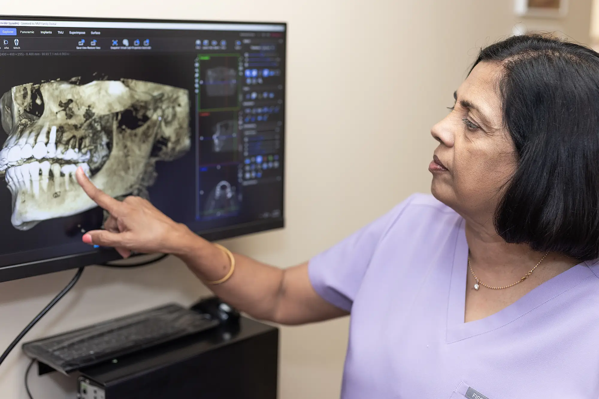 Dr. Vineetha Thomas reviewing a 3D scan of a patient's jaw