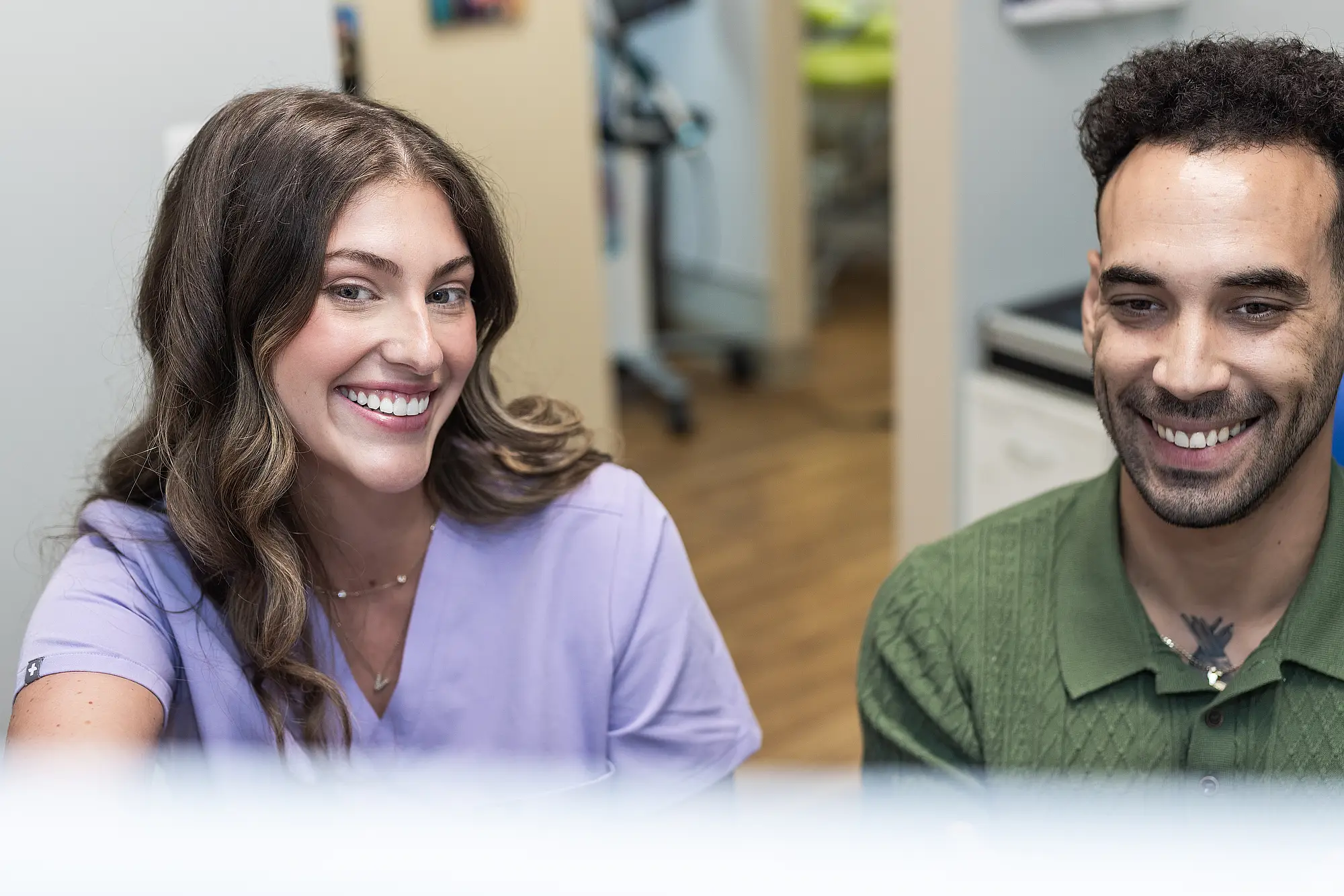 Team member and patient smiling together