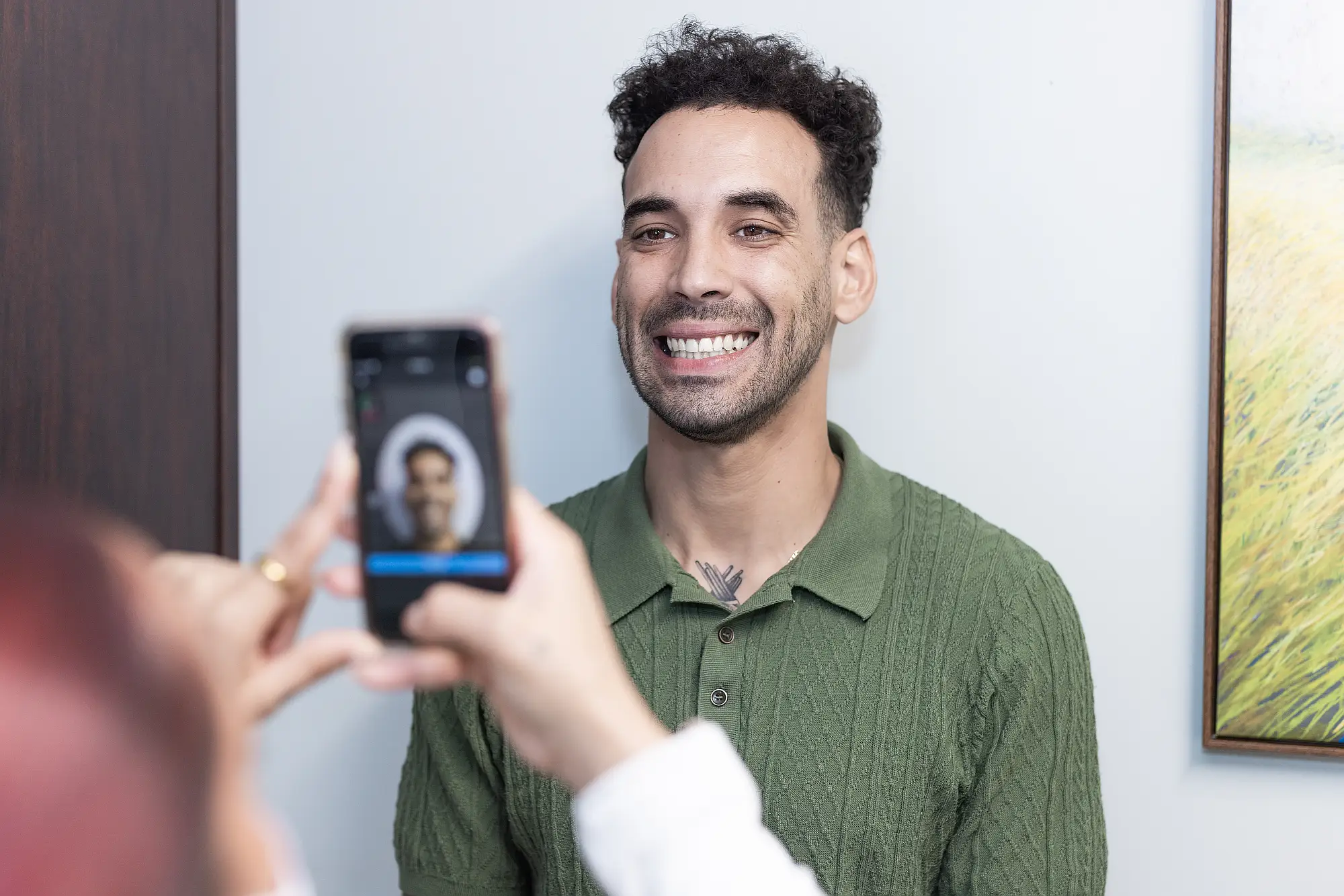 Patient having his smile photographed on a phone