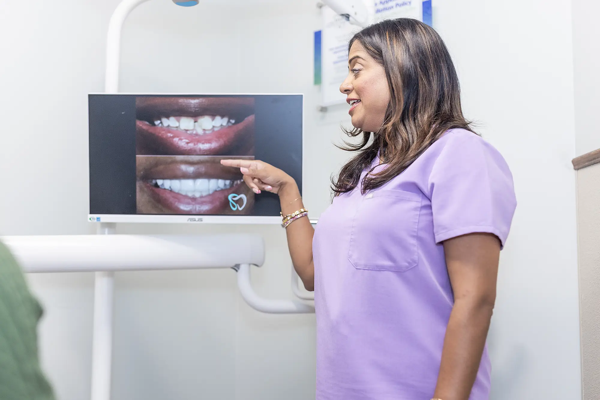Dr. Priya Mathew reviewing before and after smile photographs