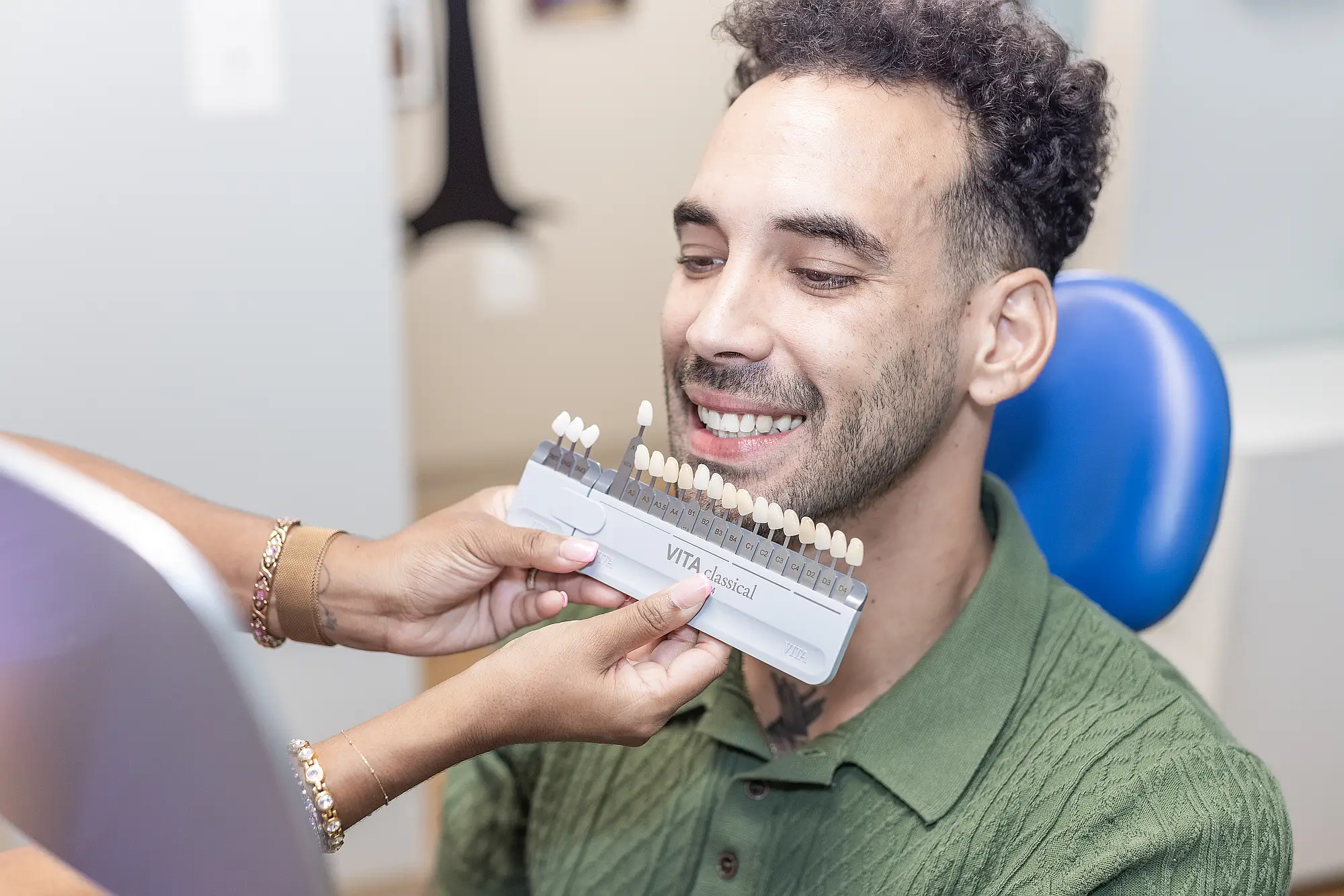Patient having his tooth shade matched with a shade guide
