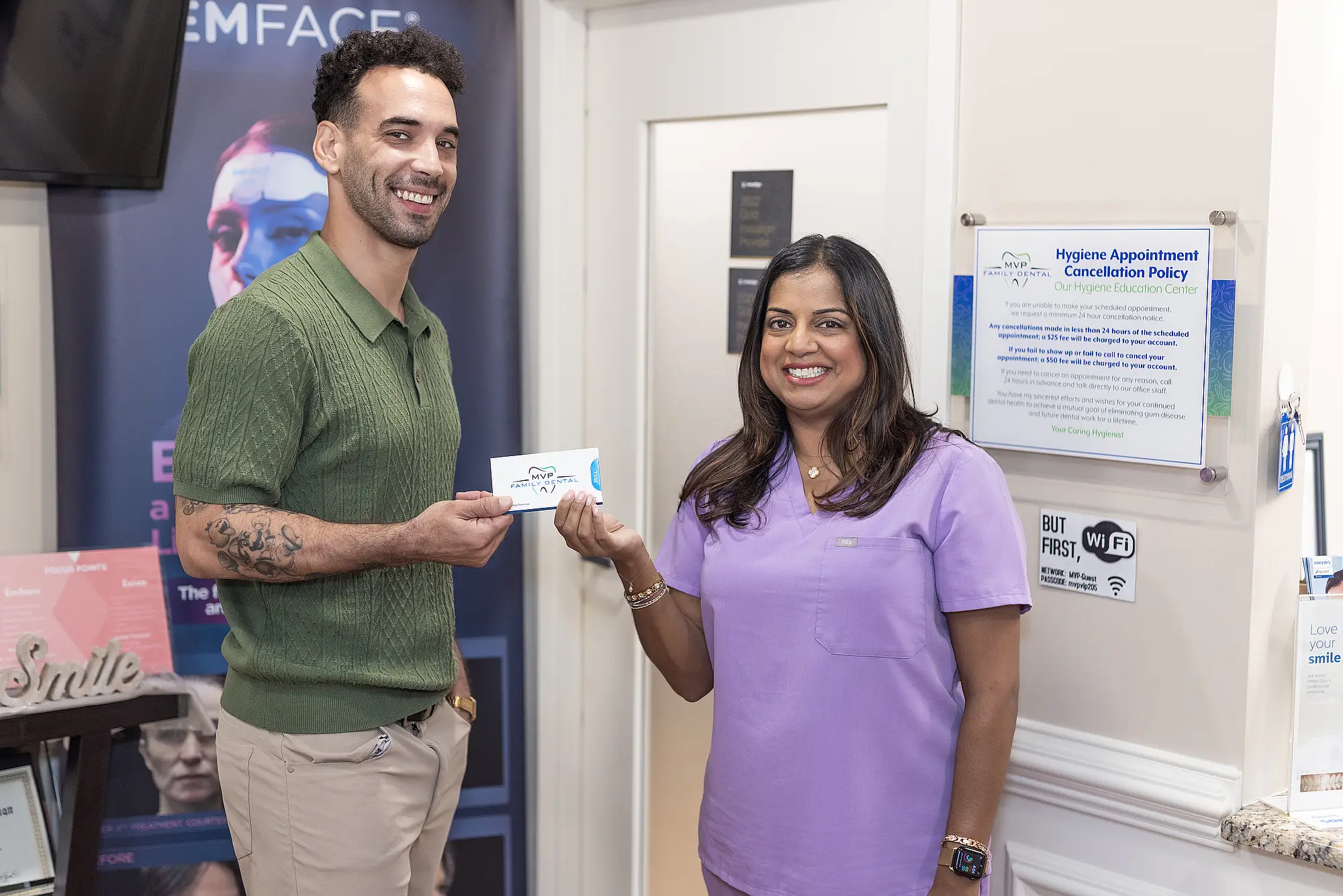 Patient receiving a card from a team member at the front desk