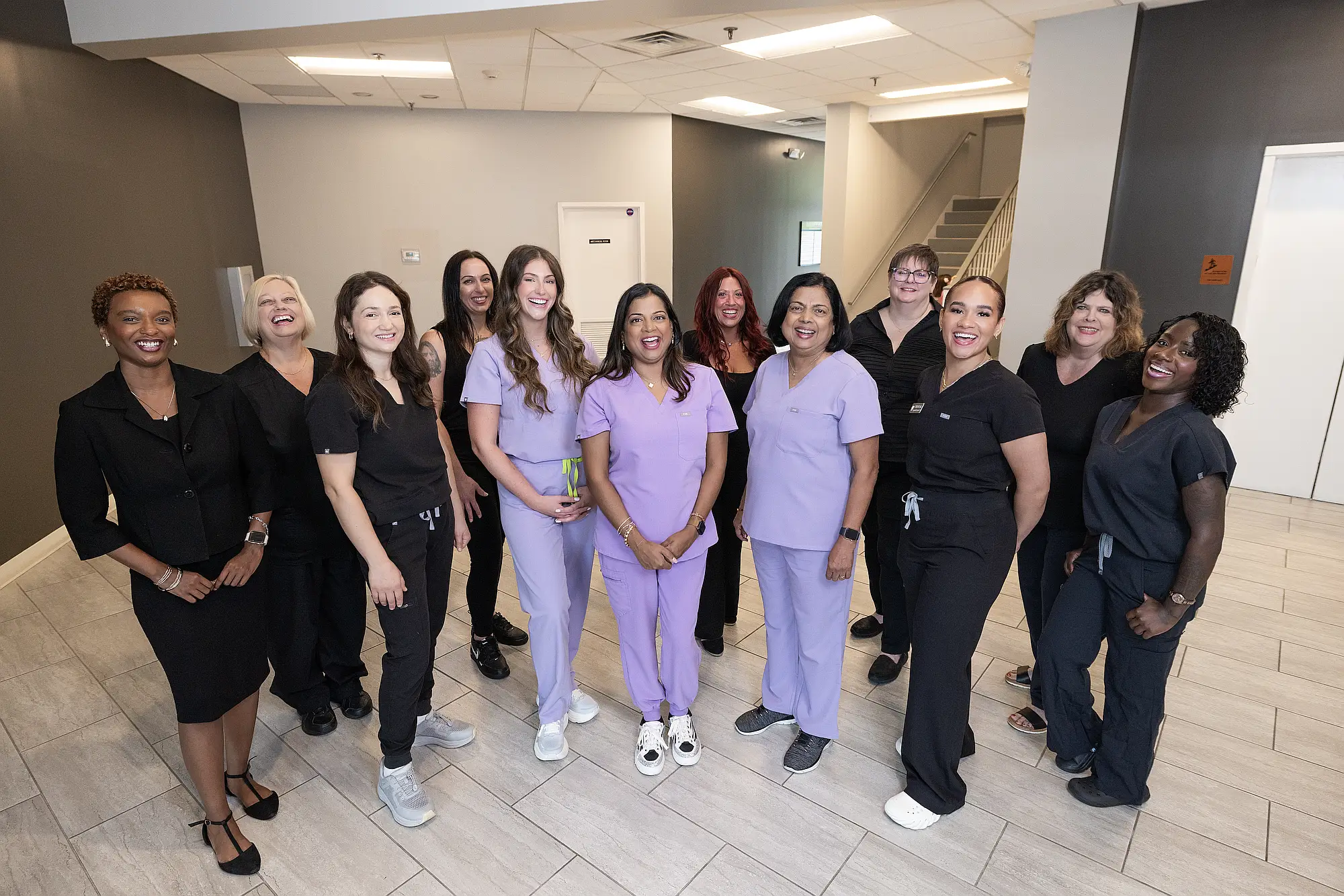 The MVP Family Dental team gathered in the practice hallway
