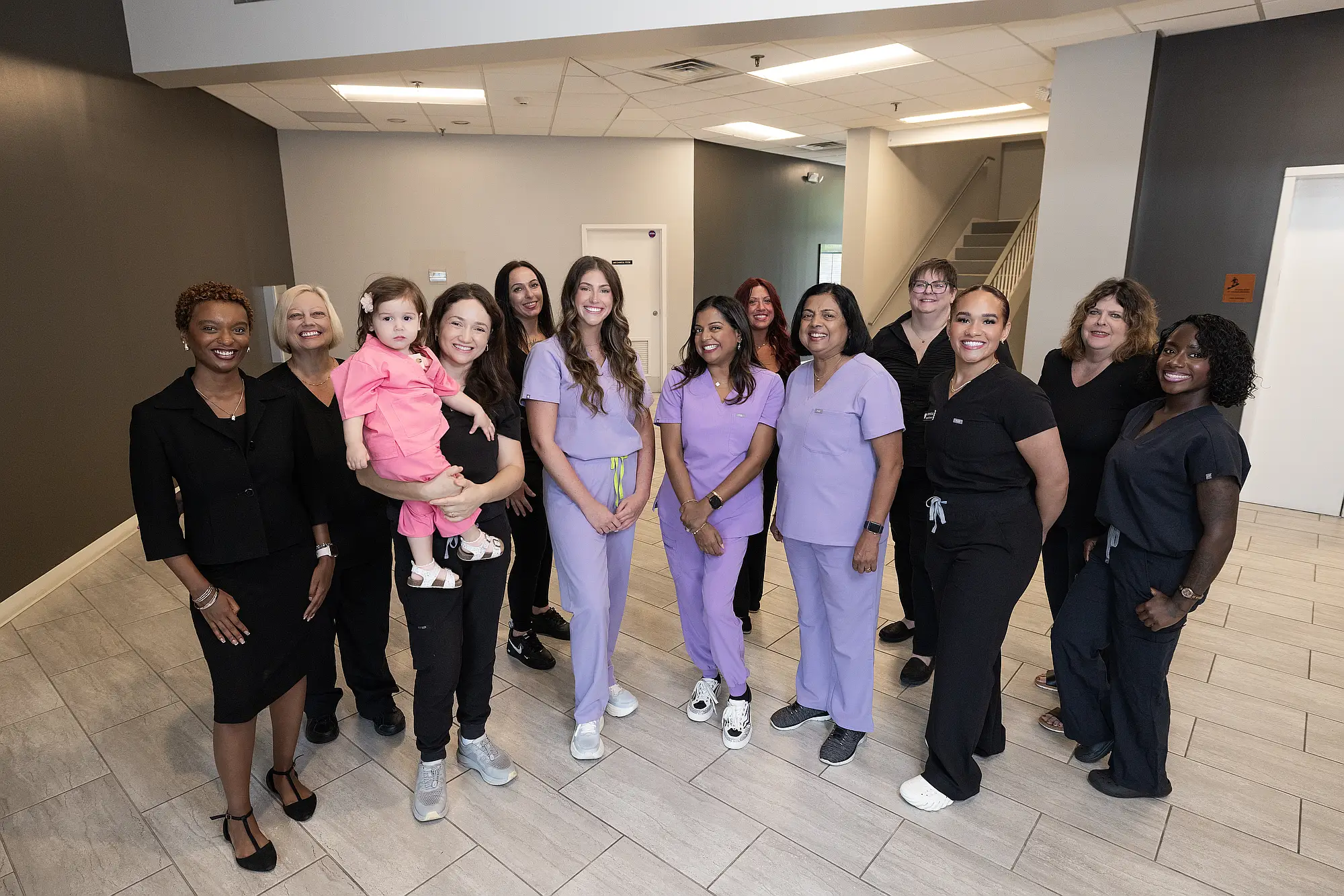 The MVP Family Dental team with a young child in the practice