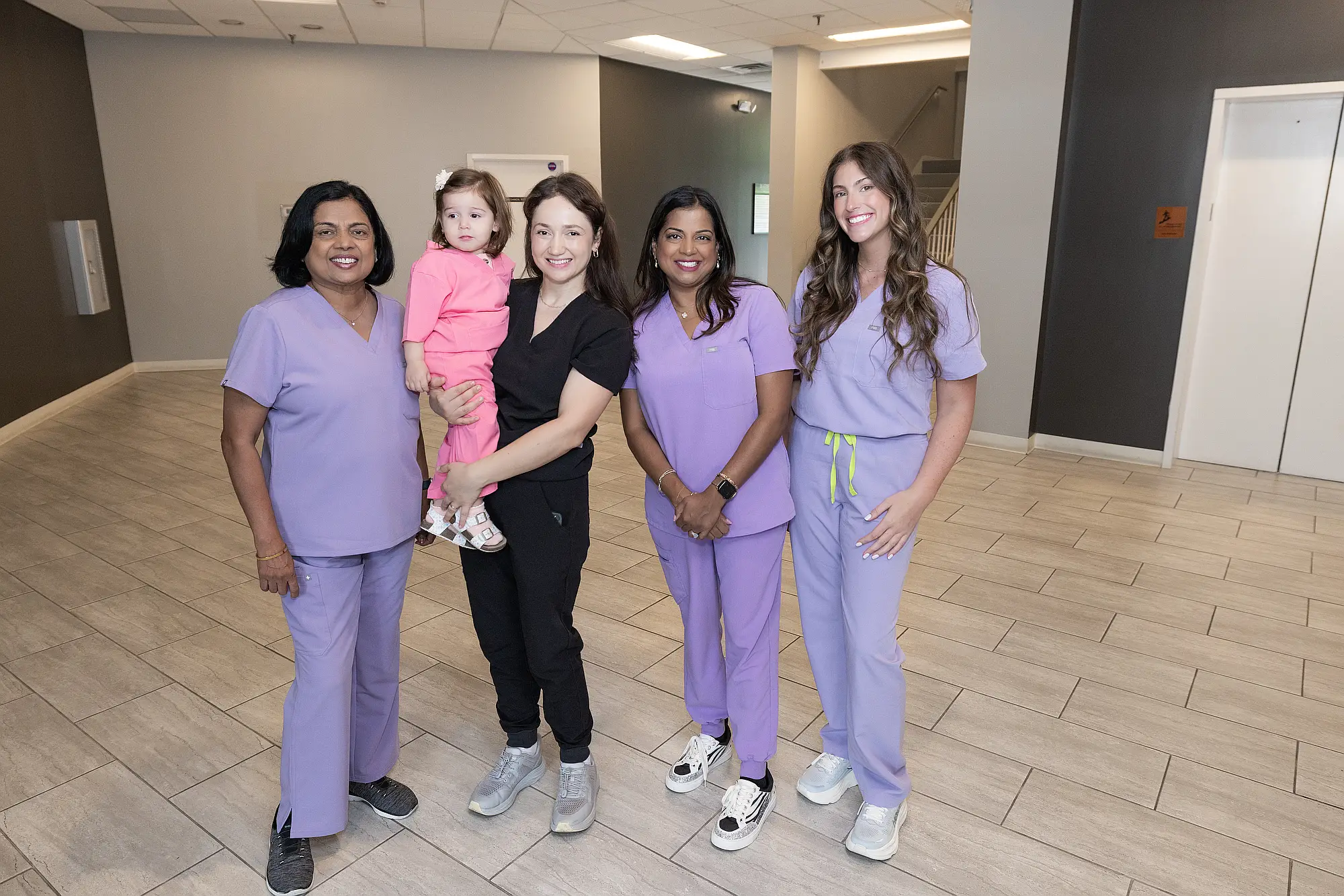 Members of the MVP Family Dental team with a young child