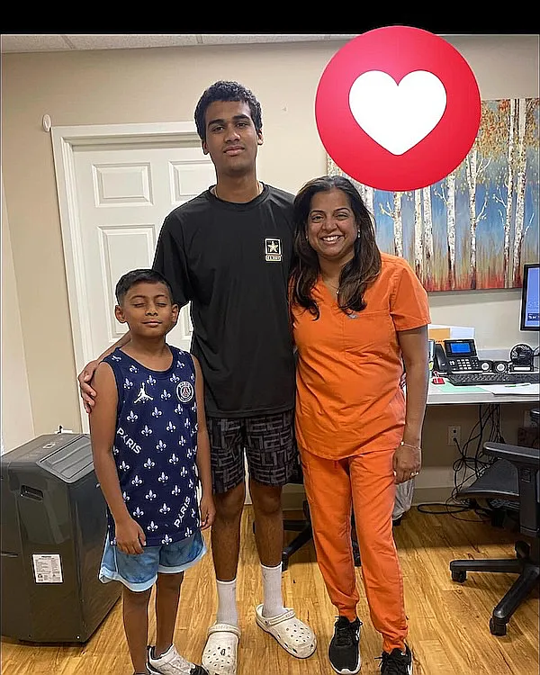A young boy with two family members beside the front desk